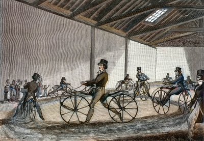 Vista interna do manège para o cavalo Hobby. Homem a conduzir bicicletas (bicicletas sem pedal, inventadas pelo Barão Karl Drais de Unknown artist