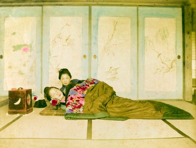 Reclinadas num futon. Duas mulheres japonesas reclinam-se num futon tradicional colocado no chão. Japão, cerca de 1910. Japão, Ásia Oriental, Ásia. ©Cultural Heritage Images/UIG/Leemage de Unknown photographer