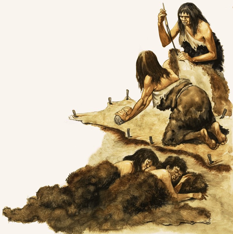 Uma família da Idade da Pedra raspa peles para fazer roupas de Peter Jackson