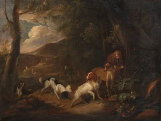 Caçador com cães à beira de uma floresta