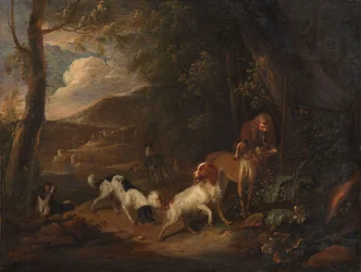 Caçador com cães de caça na orla de um bosque