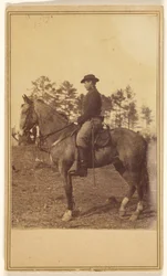 [Homem de chapéu, de perfil, a cavalo].