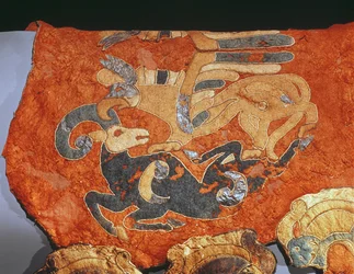 Capa de sela decorada com grifo atacando uma cabra montesa