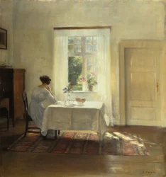 Uma mulher sentada a uma mesa junto a uma janela, c. 1900