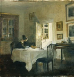 Uma mulher à mesa de uma sala de jantar