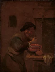 Homem a comer de uma panela de barro