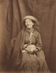 Mulher segurando um pássaro morto, asilo do condado de Surrey, c. 1855.