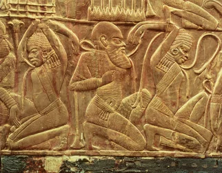 Os inimigos do Egipto vencidos e escravizados, pormenor do interior de uma das carruagens de Estado encontradas no túmulo de Tutankhamon (c.1370-52 a.C.) Novo Reino, c.1340 a.C. (madeira estucada coberta de ouro)