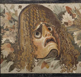Festão com máscaras, folhas e frutos