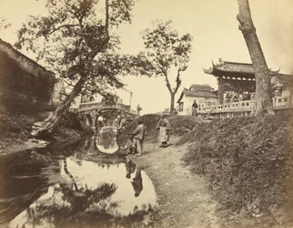 [Vista chinesa de um rio e de uma ponte numa aldeia com vários chineses].