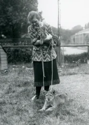 Dois filhotes de leão com uma jovem no zoológico de Londres em agosto de 1925