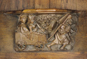 Escultura representando um casal em uma carroça puxada por um homem, de uma banca de coro (madeira)