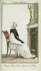 Mulher da moda sentada em frente a uma lareira