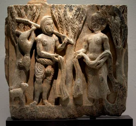 Troca de roupa com um caçador. Baixo-relevo esculpido, arte de Gandhara (Paquistão), séculos II-III. Museu Nacional da Coreia, Seul (Coreia do Sul).