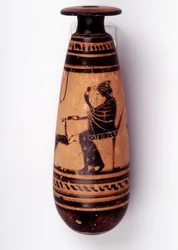 Pintura em vaso: alabastro usado para conter o perfume: um rosto retrata uma mulher brincando com uma corça e segurando uma flor. A cesta para segurar a lã está atrás dela. 500 AC. BNF, Medal Office.