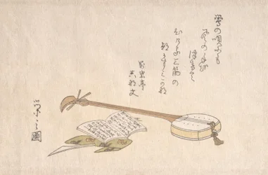 Shamisen, Plectro e um livro.