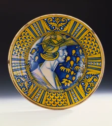 Um retrato lustrado Deruta pintado em azul e lustrado em amarelo representando um guerreiro em um capacete com um grifo alado, c.1525