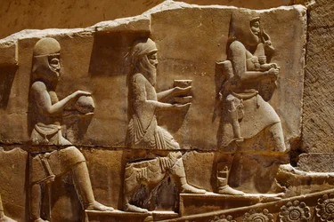 Escultura em relevo de homens carregando oferendas nas muralhas de Persépolis. Persépolis, Irão.