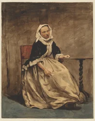 Mulher sentada ao lado de uma pequena mesa