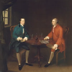 Dois cavalheiros sentados à mesa