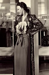 Modelo em vestido de noite criado pela casa de alta costura italiana "Dragoni". O artigo é embelezado com uma flor impressionante e complementado com um sobretudo de lantejoulas. (foto a p/b)
