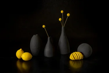 Limões amarelos, vasos pretos