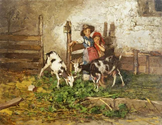 Crianças e cabras em um celeiro,