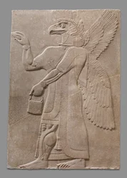 Painel em relevo de figura sobrenatural alada com cabeça de águia, c. 883-59 a.C.