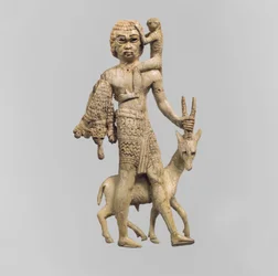 Estatueta de um homem com um orix, um macaco e uma pele de leopardo, século VIII aC