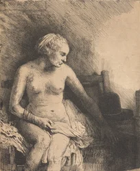 Mulher no banho, com um chapéu ao seu lado
