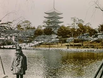 Retrato de um jovem japonês em frente a um pagode em Tóquio, cerca de 1900 - 1915 (fotografia)