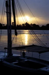 Um felucca ancorado no rio Nilo ao pôr do sol
