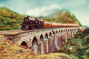 Entre Bombaim e Deli. Uma vista impressionante do Frontier Mail passando por um viaduto, 1935