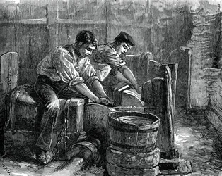 Moedores no trabalho em uma roda, c1880