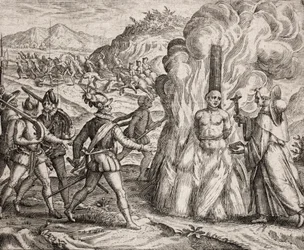 Descrição dos crimes infligidos aos índios pelos colonos espanhóis - Conquistadores queimando na fogueira um índio que se recusou a converter-se à fé católica. Religiosos da Ordem Franciscana (gravura) "Narratio regionum indicarum per Hispano