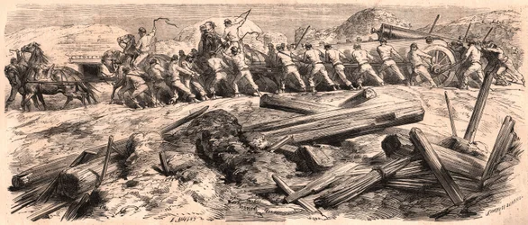 Em meio às ruínas, um time de seis cavalos rebocando peças pesadas de artilharia, um grupo de soldados acompanhou a arma enquanto outros dois lideravam os cavalos.