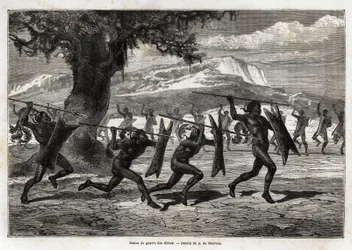 Os Obbos (tribo do Uganda) executando uma dança de guerra. Gravura para ilustrar a viagem de Sir Samuel White Baker ao Lago Albert, 1861-1864, no "Le tour du monde, nouveau journal des voyages" publicado sob a direcção de Edouard Charton