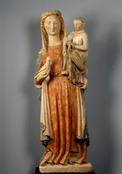 Virgem e Criança A Virgem segura uma pomba na mão. Escultura em pedra policromada. Século XV. Igreja de Montaigu les Bois.