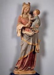 Virgem e Criança A criança segura a pomba. Escultura em pedra policromada do início do século XIV. Champeuil, igreja paroquial