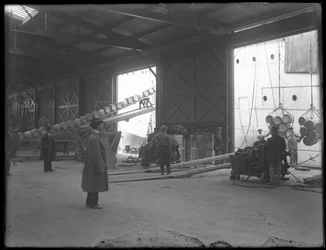 Armazém interior na doca, guinchos elétricos portáteis que estão sendo usados para descarregar o navio, 31st Street, Brooklyn, 1912